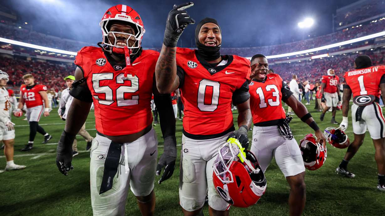 Georgia defensive lineman Christen Miller (52) and linebacker Gabe Harris Jr. (0) react after an NCAA college football game against Texas, Saturday, Nov. 15, 2025, in Athens, Ga.