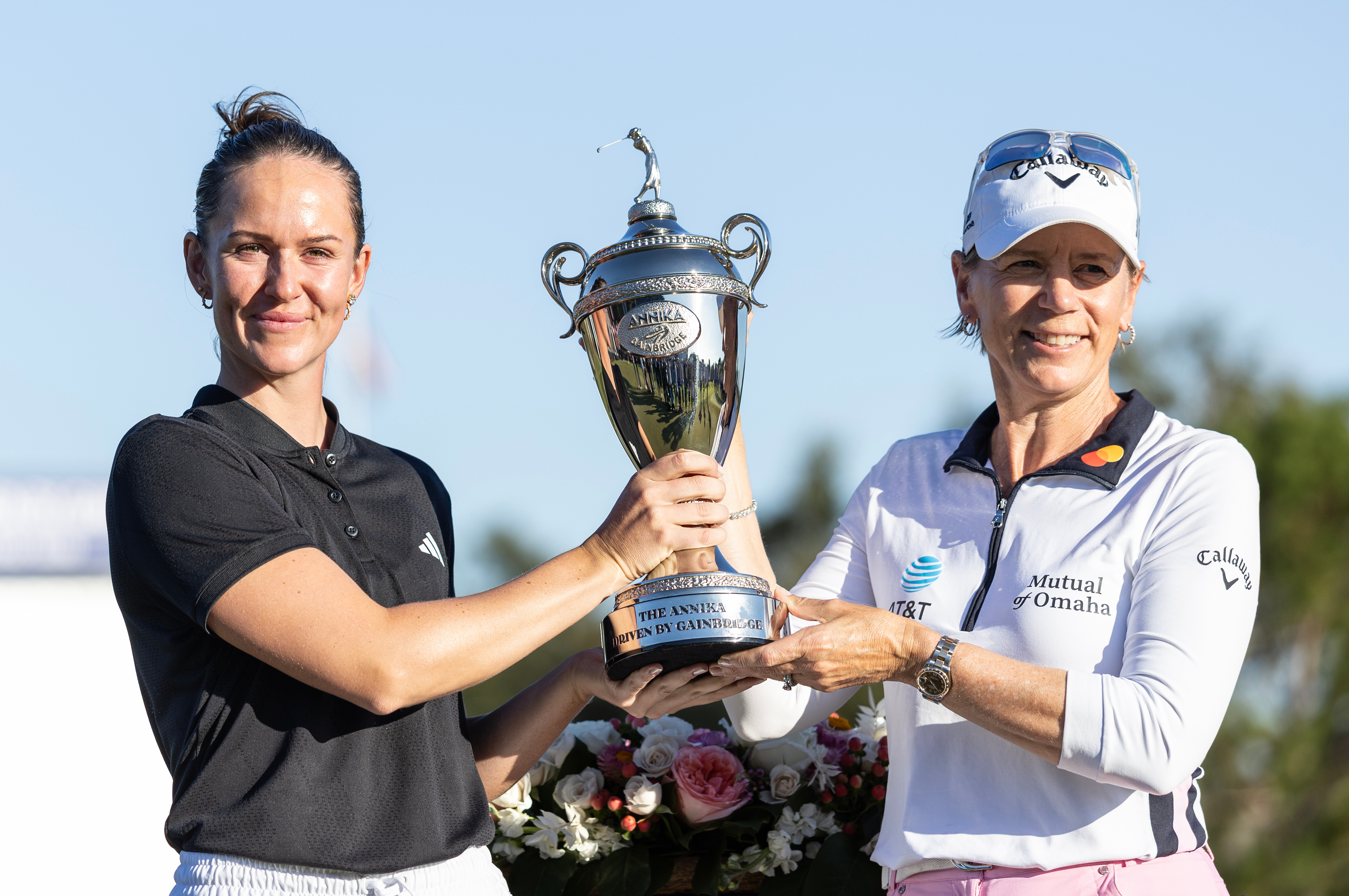Linn Grant, left, and Annika Sorenstam, right, hold the championship trophy after Grant's win on the final day of The Annika LPGA golf tournament in Belleair, Fla., Sunday, Nov. 16, 2025.