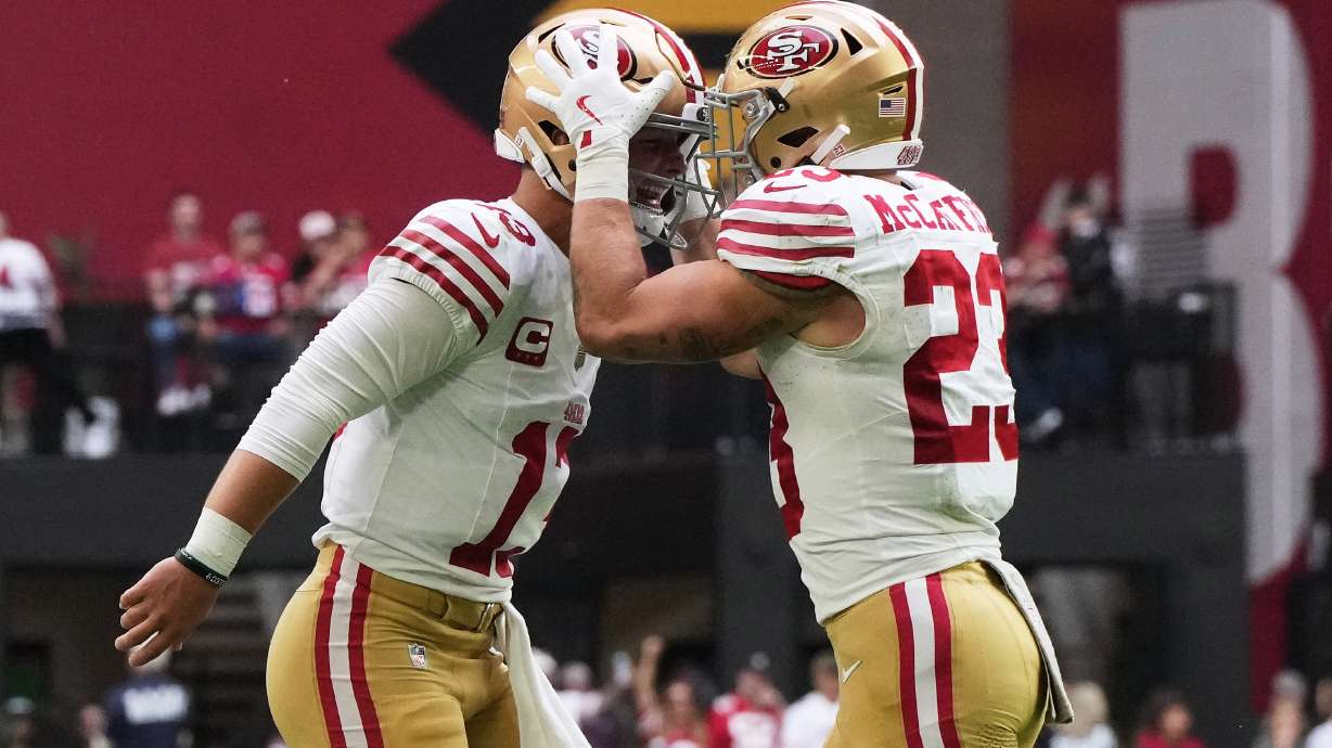 San Francisco 49ers quarterback Brock Purdy, left, and running back Christian McCaffrey celebrate after connecting on a touchdown pass against the Arizona Cardinals during the first half of an NFL football game in Glendale, Ariz., Sunday, Nov. 16, 2025.