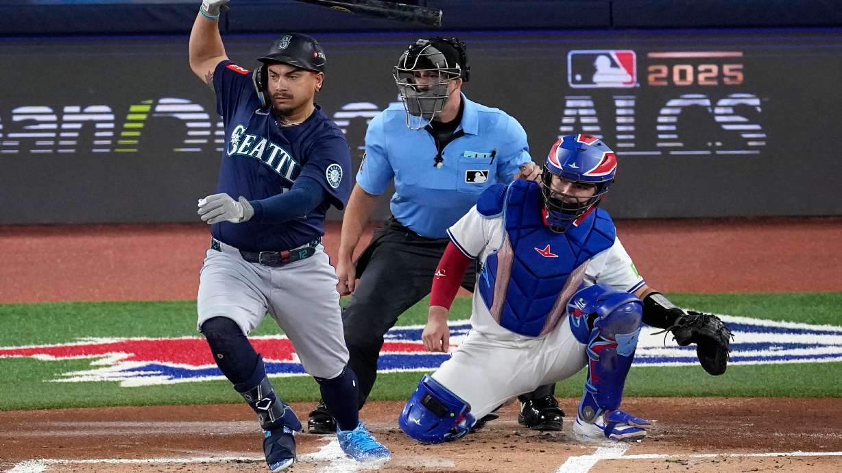 Seattle Mariners' Josh Naylor follows through on an RBI base hit off Toronto Blue Jays pitcher Shane Bieber (57) during the first inning in Game 7 of baseball's American League Championship Series, Monday, Oct. 20, 2025, in Toronto.