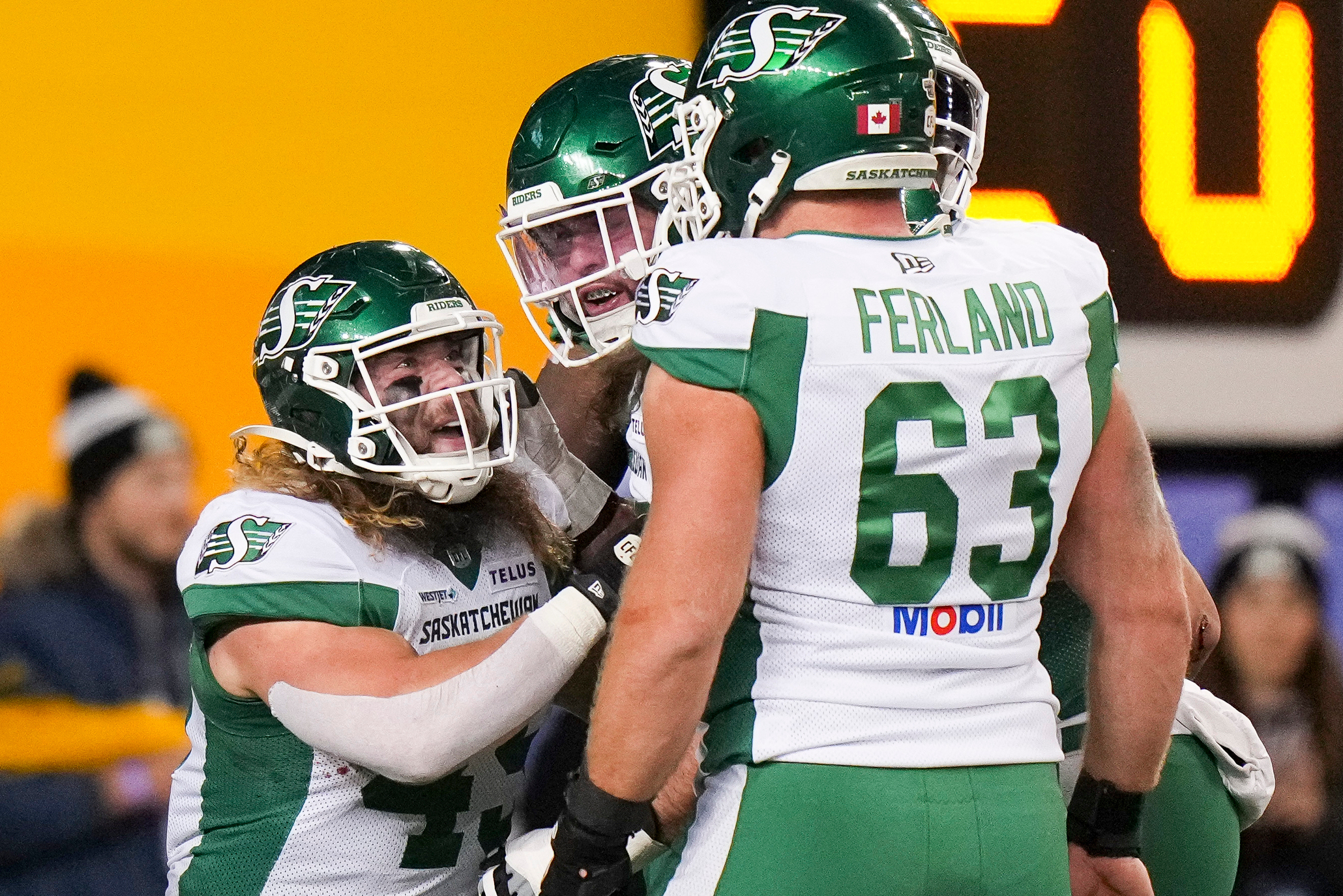 Saskatchewan Roughriders' A.J. Ouellette (45), left, celebrates his touchdown with teammates while taking on the Montreal Alouettes during first half CFL football action in the Grey Cup in Winnipeg, Manitoba, Sunday, Nov. 16, 2025.