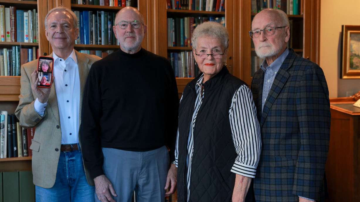 Scott Howell holds a phone with Joanne Neumann, Bob Weidner, Kimball Young, Alvina Wall, and Dan Wall, after a meeting at the Alta Club in Salt Lake City on Nov. 3. All of them have worked for former Utah politician Jake Garn.