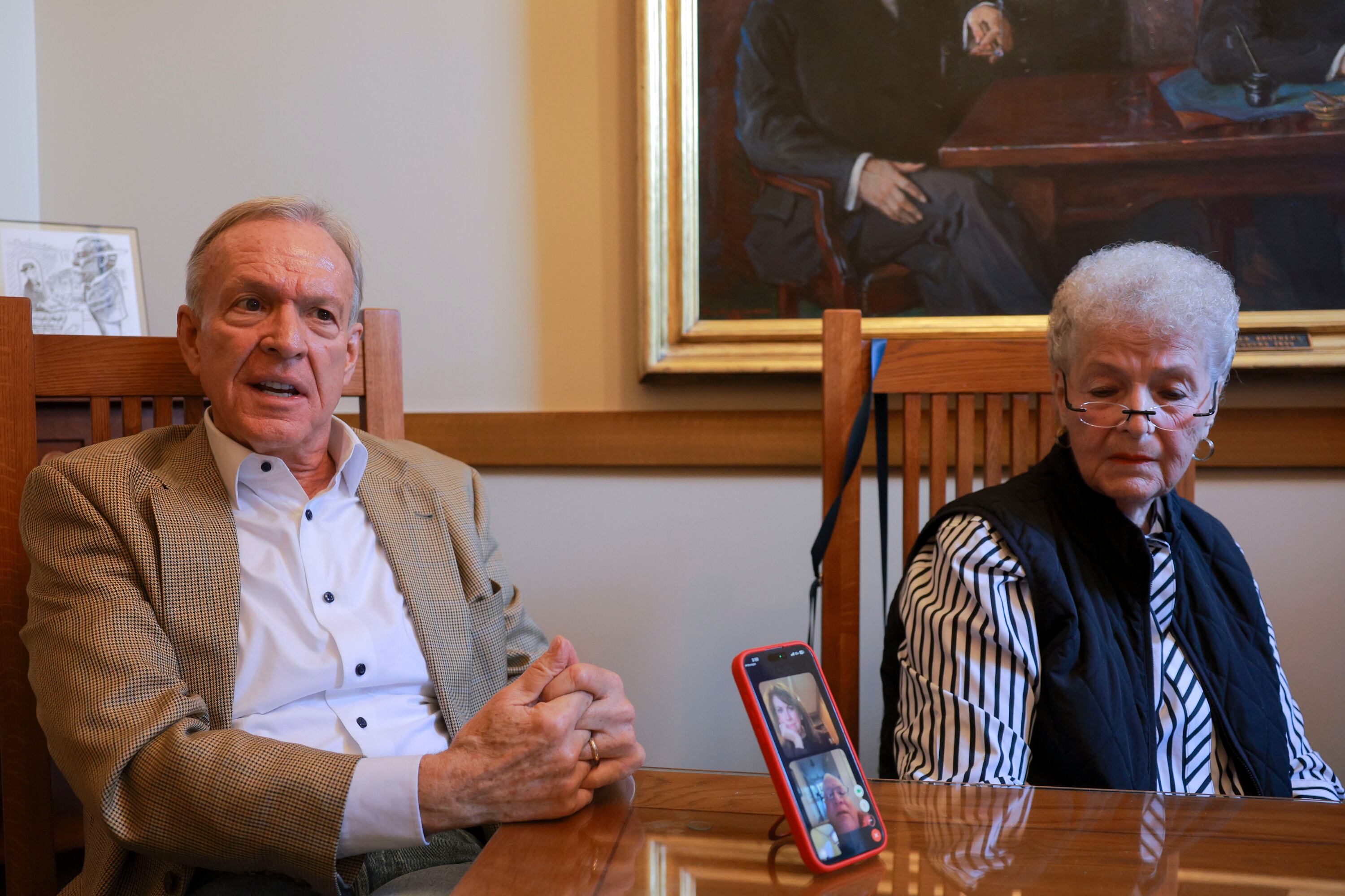 Scott Howell, left, speaks during a meeting of the “Jake Garn Legacy Team” as Alvina Wall, right, looks on with Joanne Neumann, top of phone, and Bob Weidner, bottom of phone, tuning in remotely from Washington, D.C., and Gettysburg, Pa., at the Alta Club in Salt Lake City on Nov. 3. Howell said Garn embodied what good government service should be.