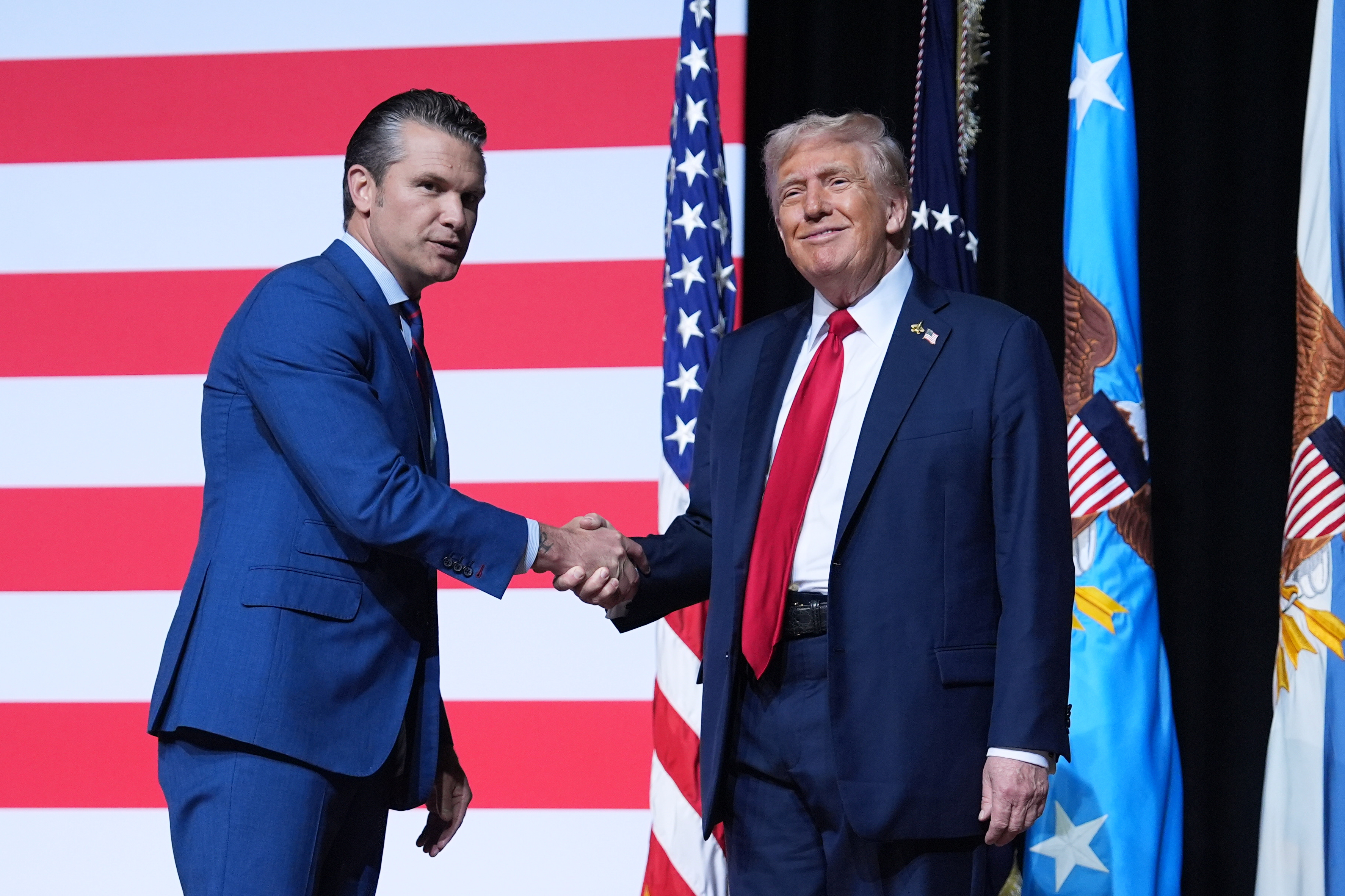 President Donald Trump is greeted by Secretary of Defense Pete Hegseth before speaking to a gathering of top military commanders at Marine Corps Base Quantico, Sept. 30, in Quantico, Va. Hegseth claimed last month Scouting America has become "too woke" to support.