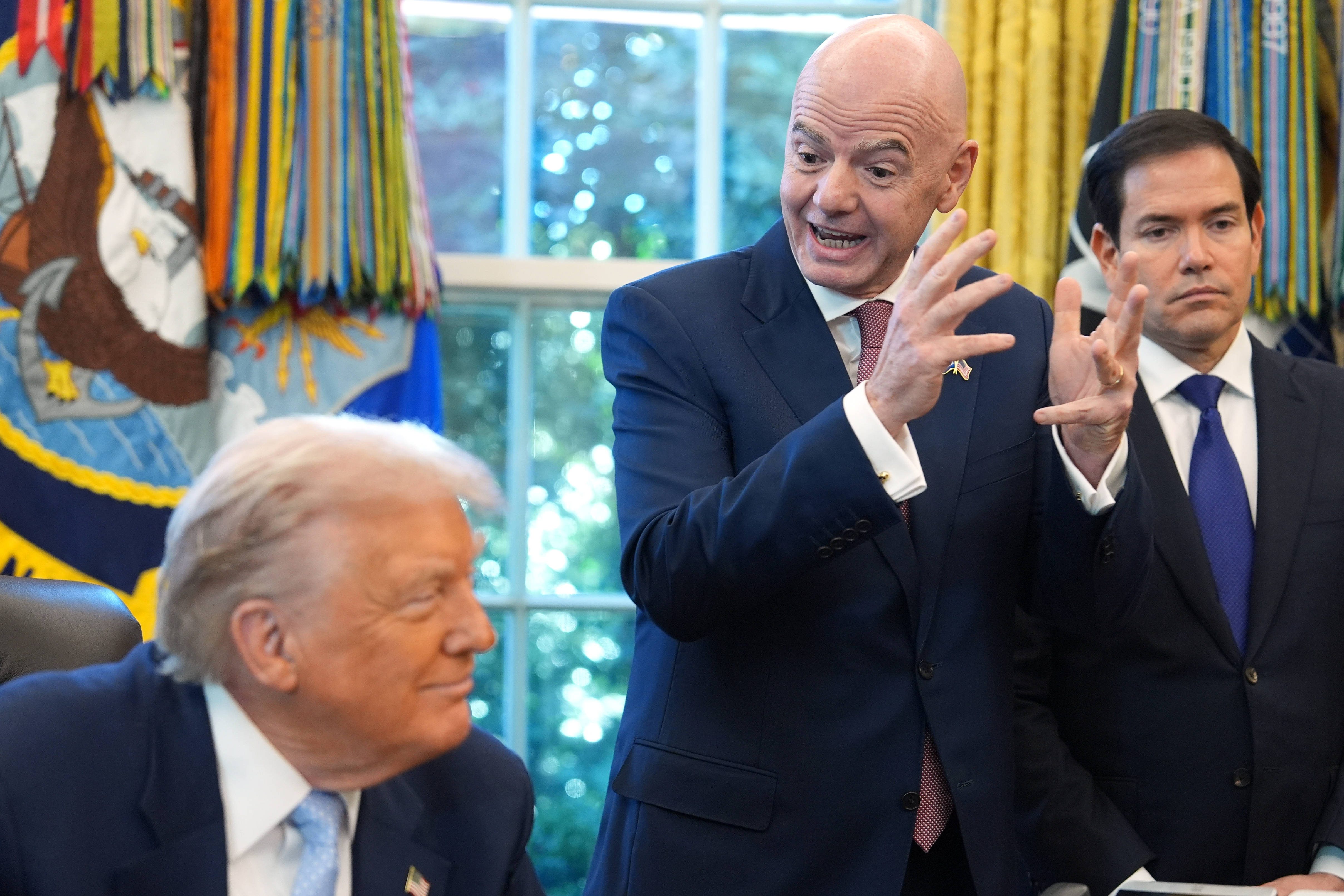 President Donald Trump and Secretary of State Marco Rubio listen as FIFA President Gianni Infantino speaks during a meeting with the White House task force on the 2026 FIFA World Cup in the Oval Office of the White House, Monday, Nov. 17, 2025, in Washington.