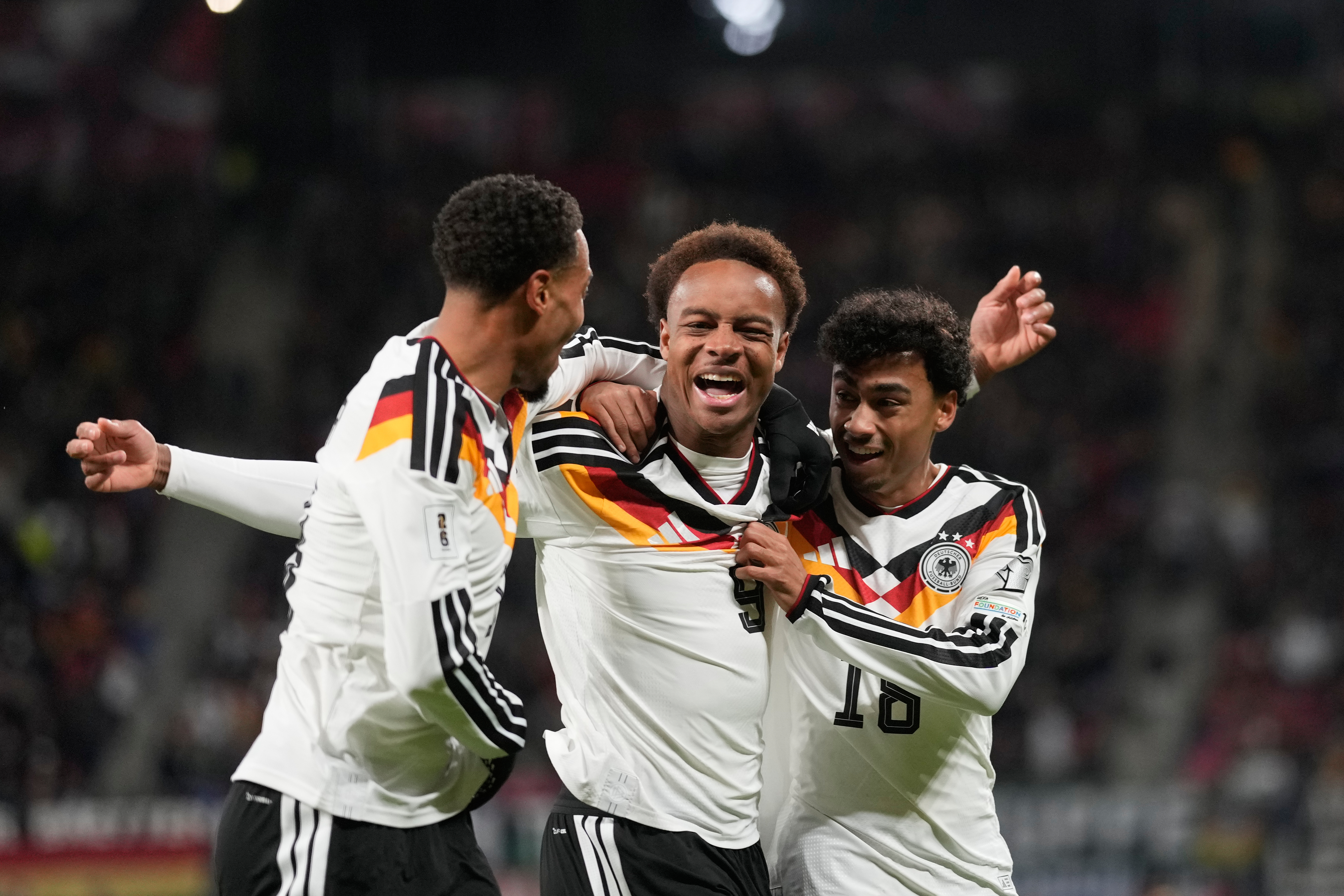 Germany's Assan Ouedraogo, center, celebrates after scoring during a group A World Cup qualifiying soccer match between Germany and Slovakia in Leipzig, Germany, Monday, Nov. 17, 2025.