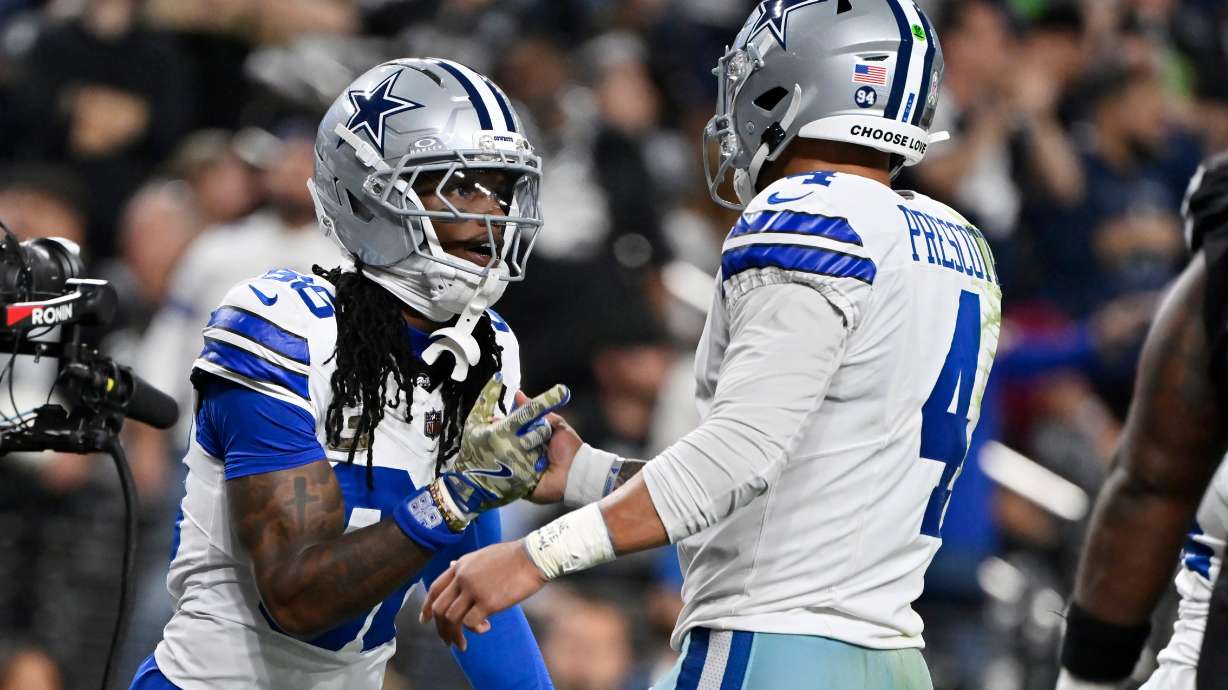 Dallas Cowboys wide receiver CeeDee Lamb, left, celebrates his touchdown against the Las Vegas Raiders with Cowboys quarterback Dak Prescott (4) during the first half of an NFL football game Monday, Nov. 17, 2025, in Las Vegas.