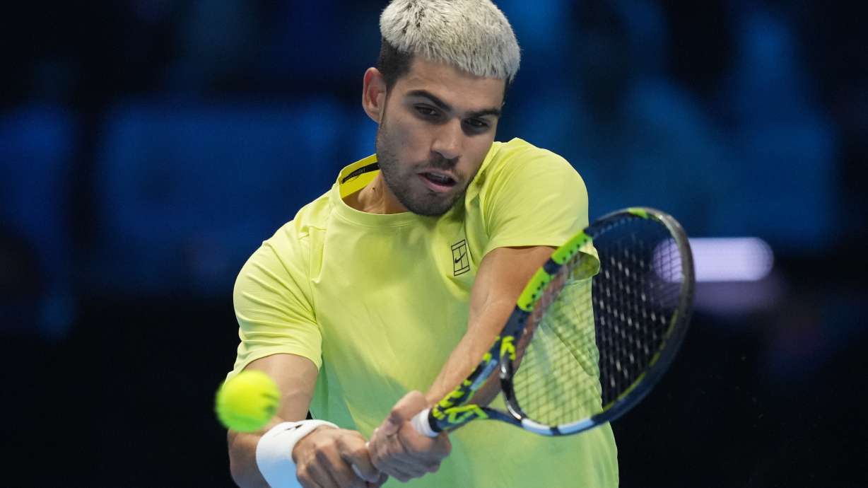 Spain's Carlos Alcaraz returns to Italy's Jannik Sinner during the final tennis match of the ATP World Tour Finals, in Turin, Italy, Sunday, Nov. 16, 2025.