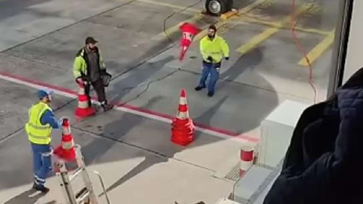 Workers at Porto Airport in Portugal keep themselves busy Oct. 23.