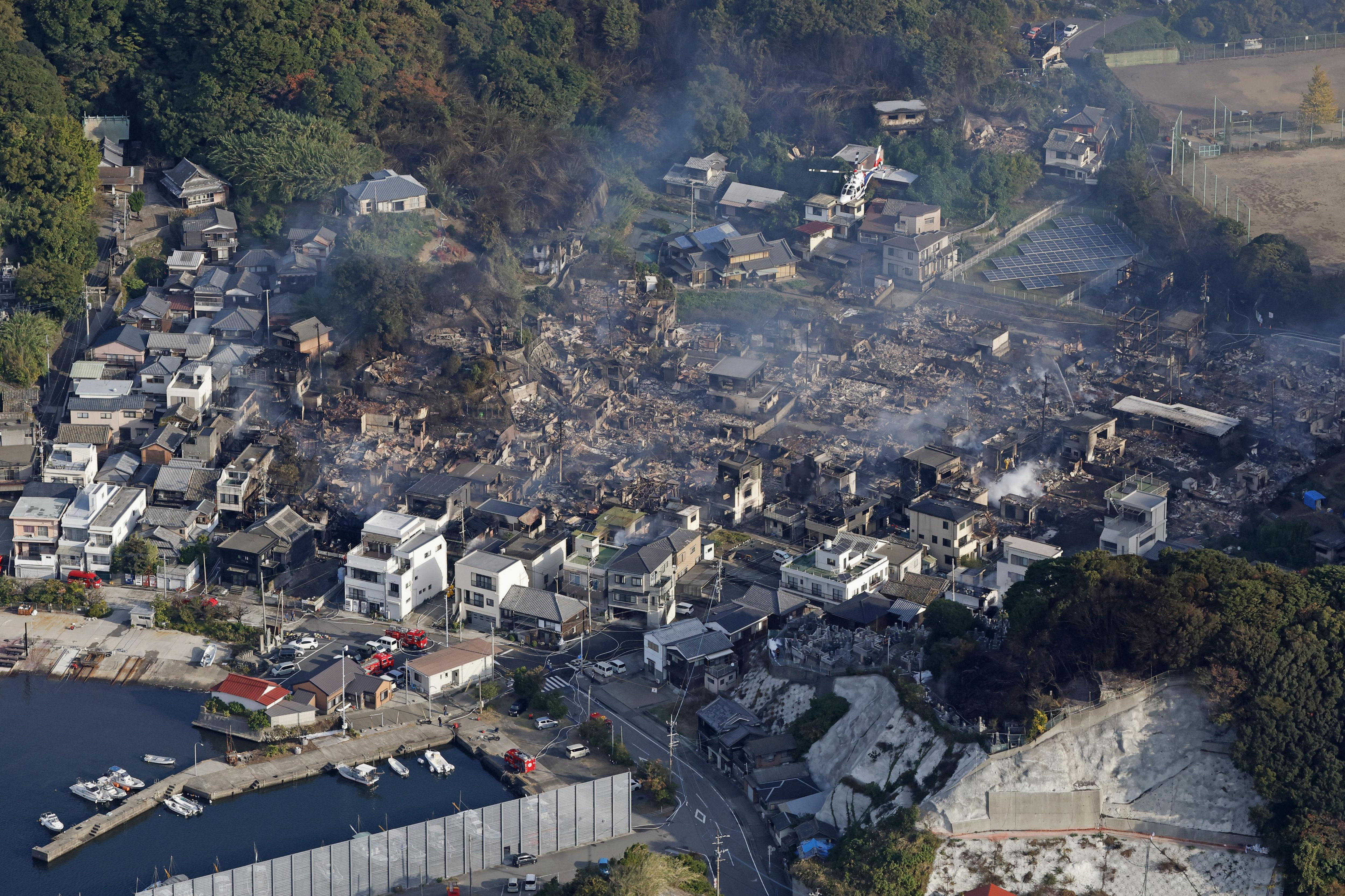 This shows the aftermath of a fire in Oita, southern Japan, Wednesday. Firefighters and army helicopters battled the fire that burned through a neighborhood of old wooden houses in a fishing town.