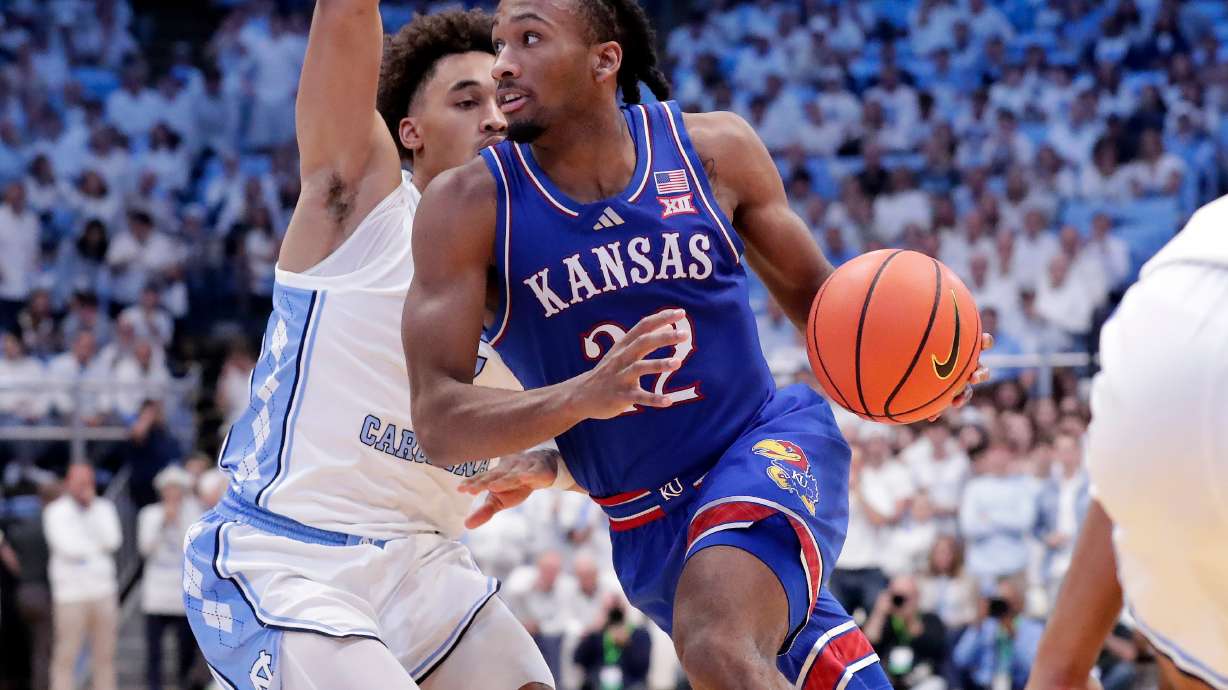 Kansas guard Darryn Peterson, right, drives against North Carolina guard Seth Trimble, left, during the second half of an NCAA college basketball game Friday, Nov. 7, 2025, in Chapel Hill, N.C.