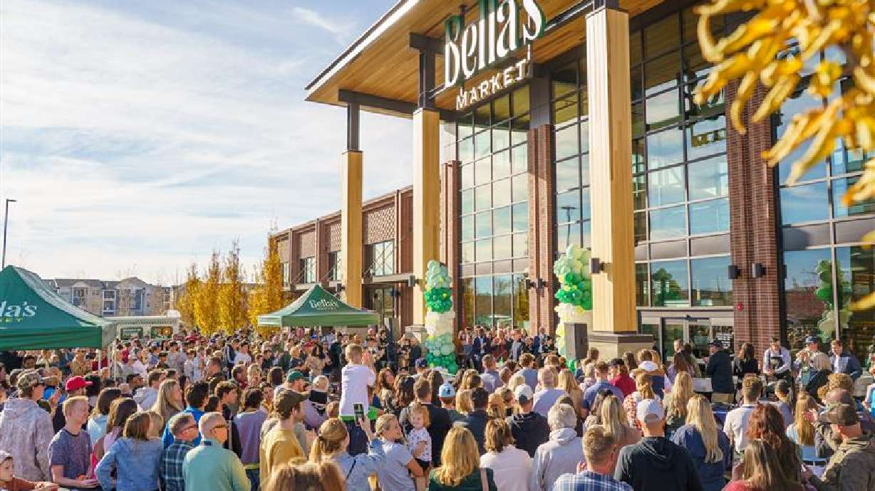 People gather outside of Bella's Market in Vineyard for a grand opening celebration on Saturday.
