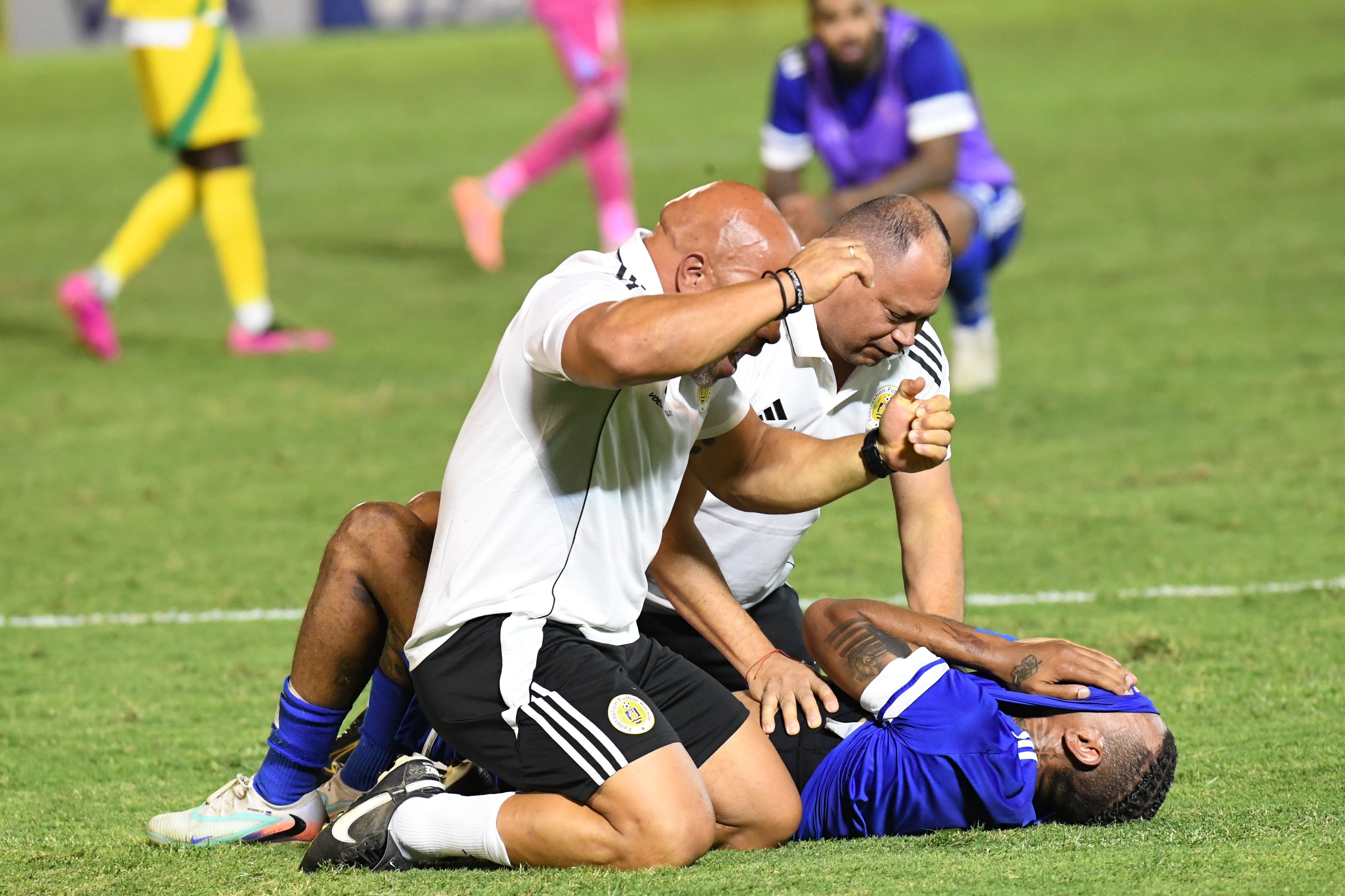 Curacao players and trainers celebrate qualifying for the 2026 FIFA World Cup after their game with Jamaica in Kingston, Jamaica, Tuesday, Nov. 18, 2025. 