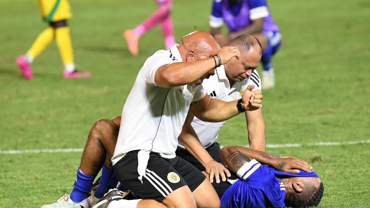 Curacao players and trainers celebrate qualifying for the 2026 FIFA World Cup after their game with Jamaica in Kingston, Jamaica, Tuesday, Nov. 18, 2025.