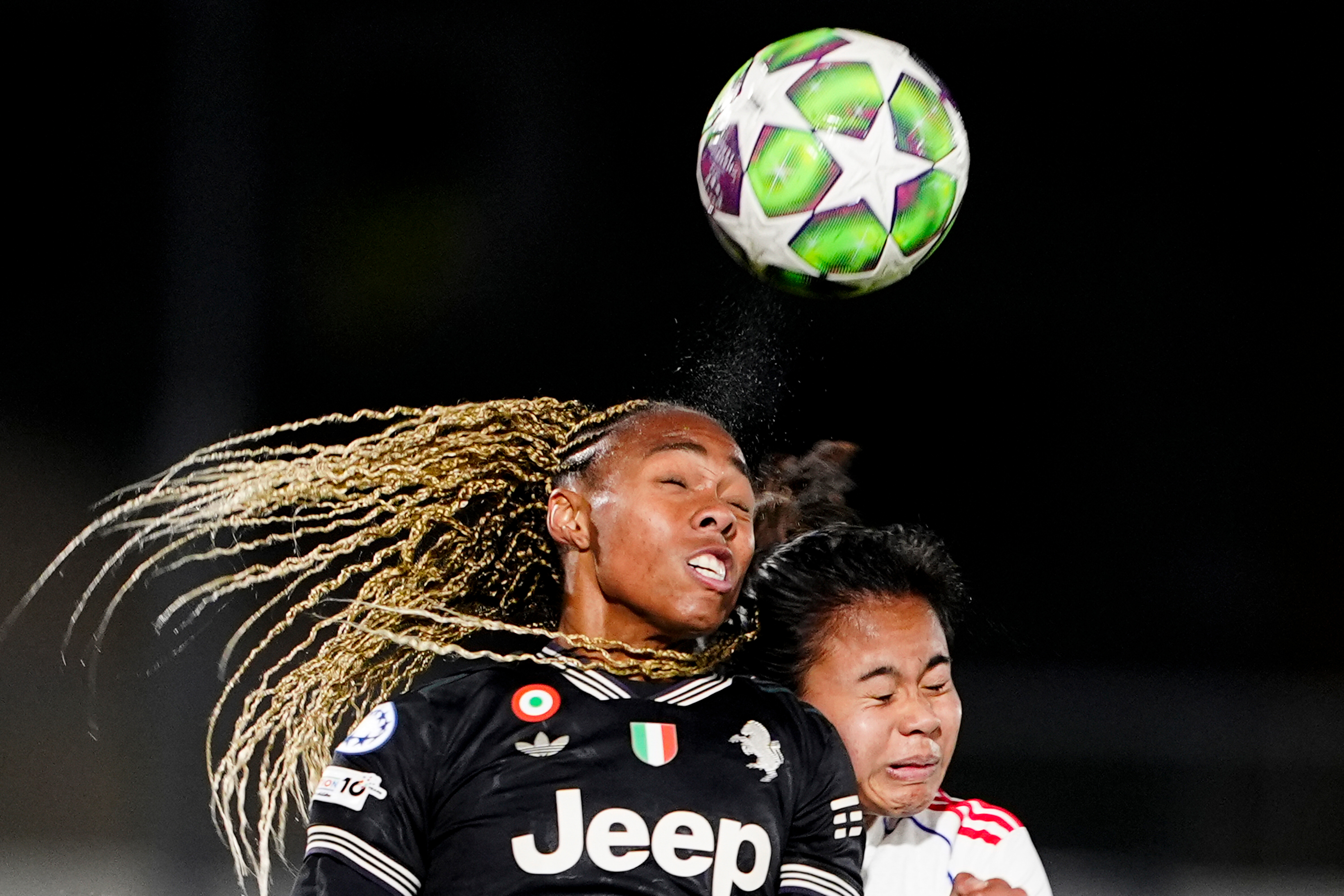 OL Lyonnes's Alice Sombath, right, jumps for the ball with Juventus' Lindsey Thomas during the women's Champions League soccer match between Juventus and OL Lyonnes in Biella, Italy, Wednesday, Nov. 19, 2025. 