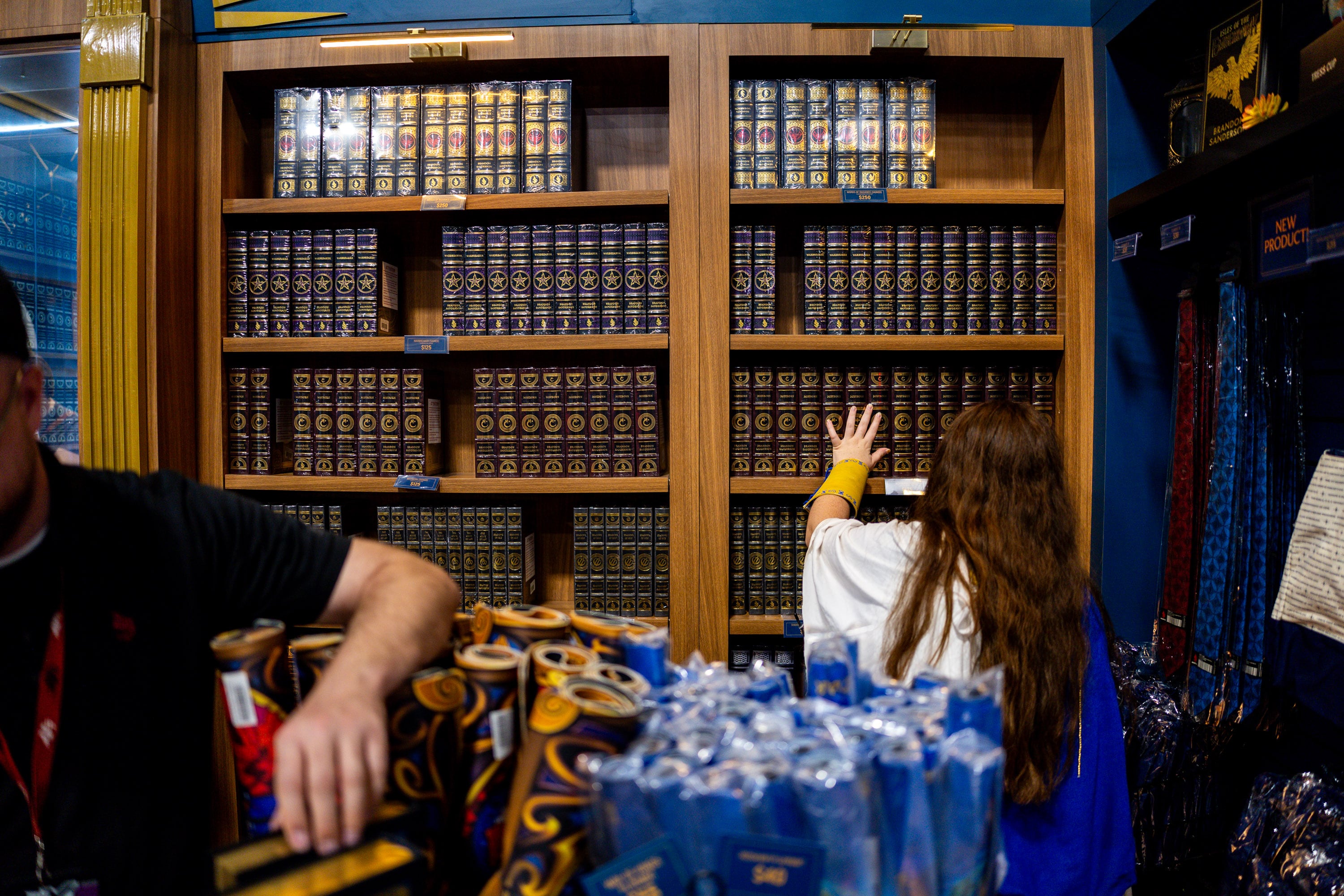 People shop at author Brandon Sanderson’s Dragonsteel Books vendor booth at FanX Salt Lake Pop Culture and Comic Convention at the Salt Palace Convention Center in Salt Lake City on Sept. 26.