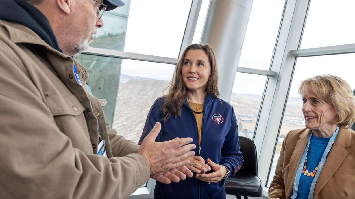 Dwayne Tuggle, mayor of Amherst, Va., left, and Kelly Burk, mayor of Leesburg, Va., right, speak with Salt Lake City Mayor Erin Mendenhall at the Utah Olympic Park in Park City on Wednesday.