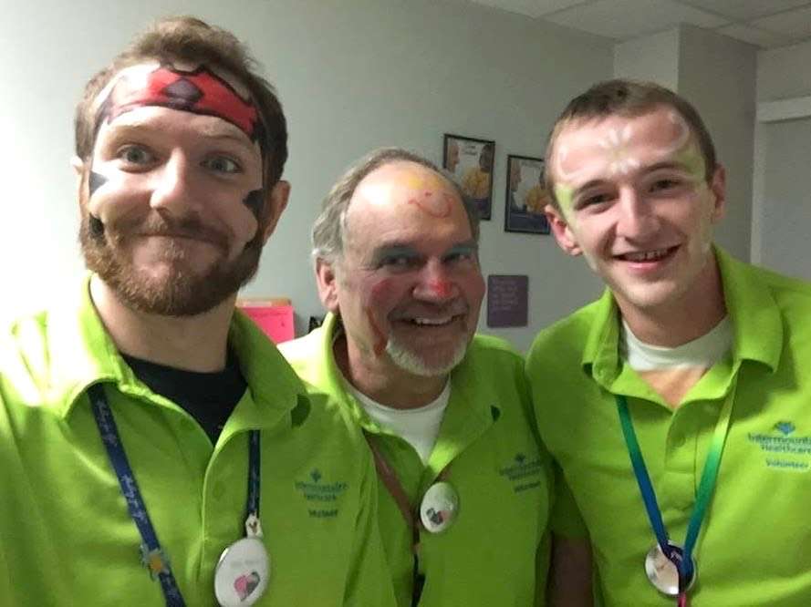 The running community is remembering last-place finisher Kimball Webb, center, for his selfless acts. Webb, 73, who passed away from a heart attack on Nov. 1, would collect race medals to hand out to kids at Primary Children's Hospital and served regularly at the hospital.