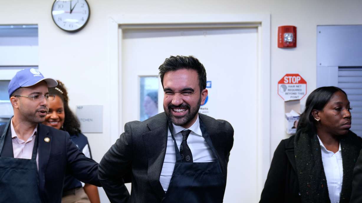 New York City mayor-elect Zohran Mamdani laughs after helping to serve meals at at POTS, a Bronx nonprofit that provides food assistance, in New York, Monday.