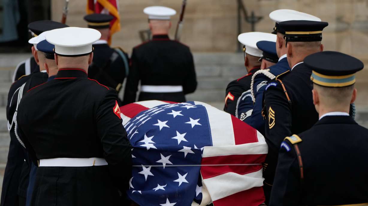 A joint services body bearer team carries the flag-draped casket of former Vice President Dick Cheney into the Washington National Cathedral, Thursday in Washington.