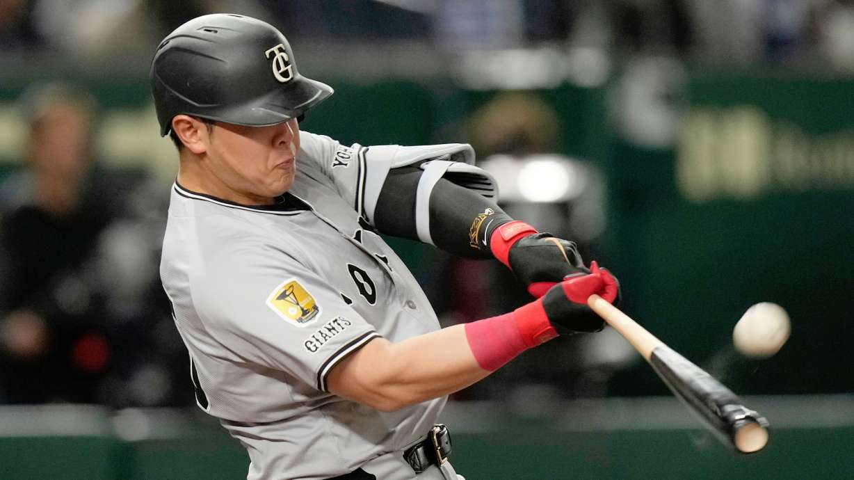 FILE - Yomiuri Giants' Kazuma Okamoto flies out in the fourth inning of a spring training baseball game against the Los Angeles Dodgers in Tokyo, Japan, Saturday, March 15, 2025.