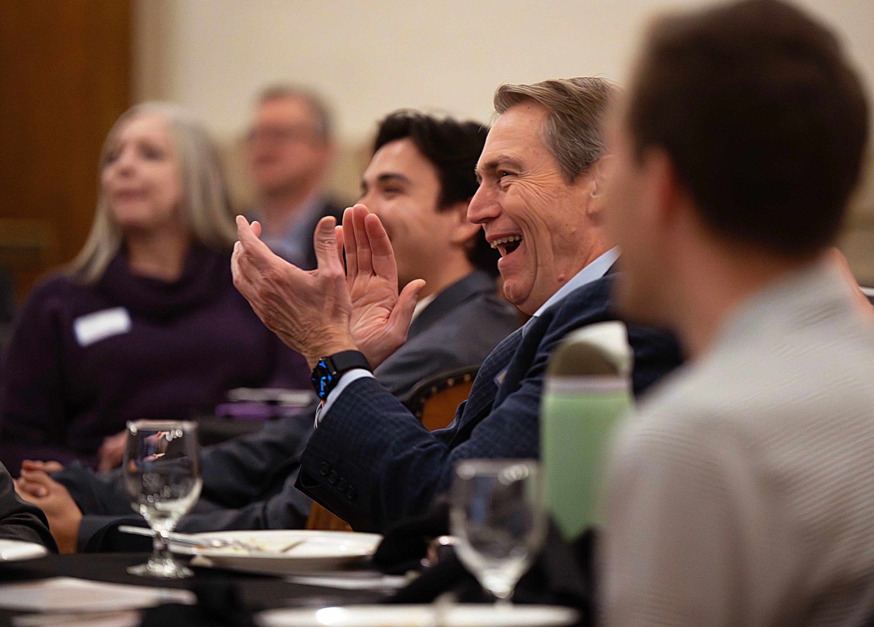 A member of the audience applauds as Principles First holds a first-in-Utah dinner and discussion at the Clubhouse in Salt Lake City on Wednesday. Former presidential candidate John Kasich was one of the speakers.
