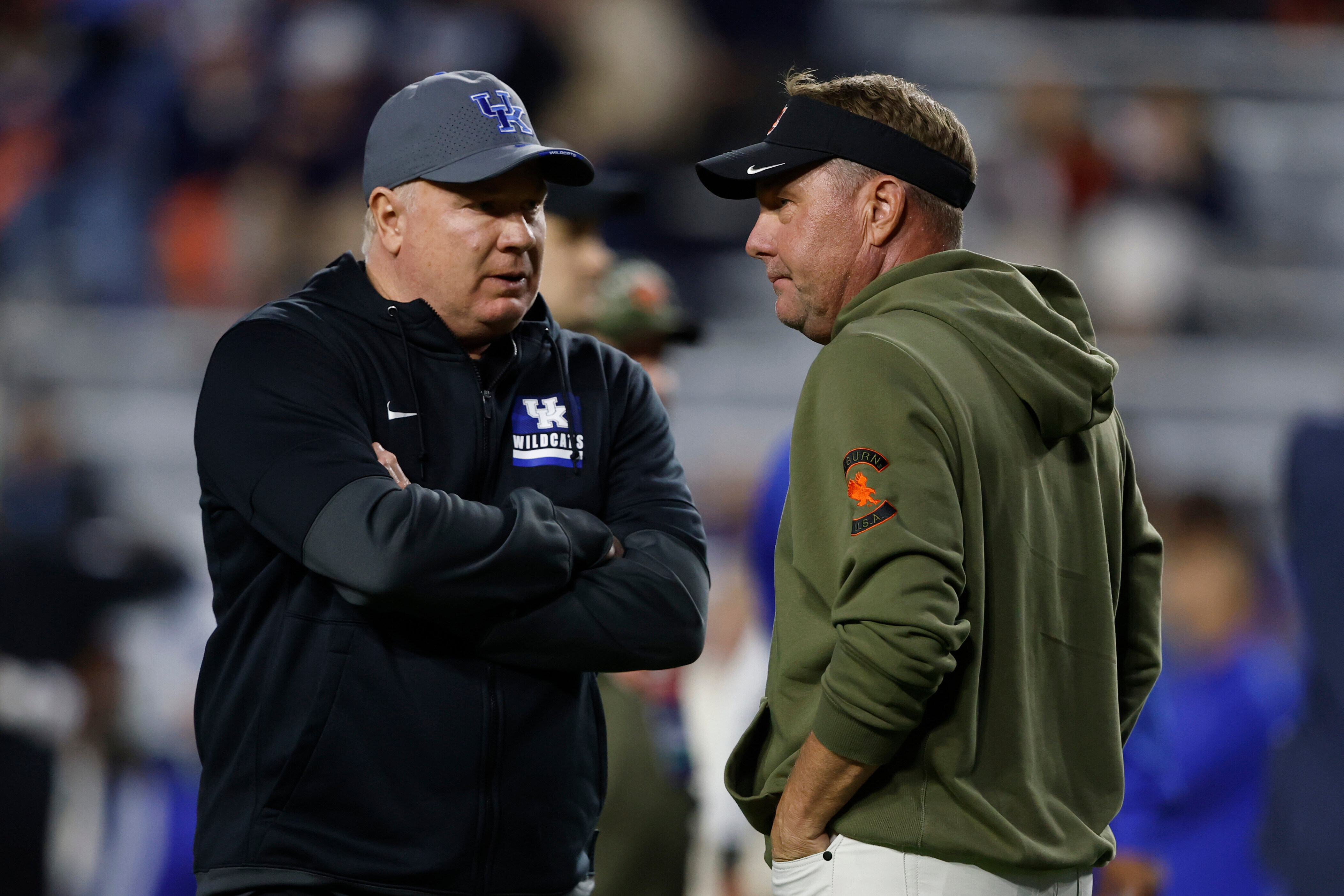 Kentucky head coach Mark Stoops talks with Auburn head coach Hugh Freeze before an NCAA college football game, Saturday, Nov. 1, 2025, in Auburn, Ala. 