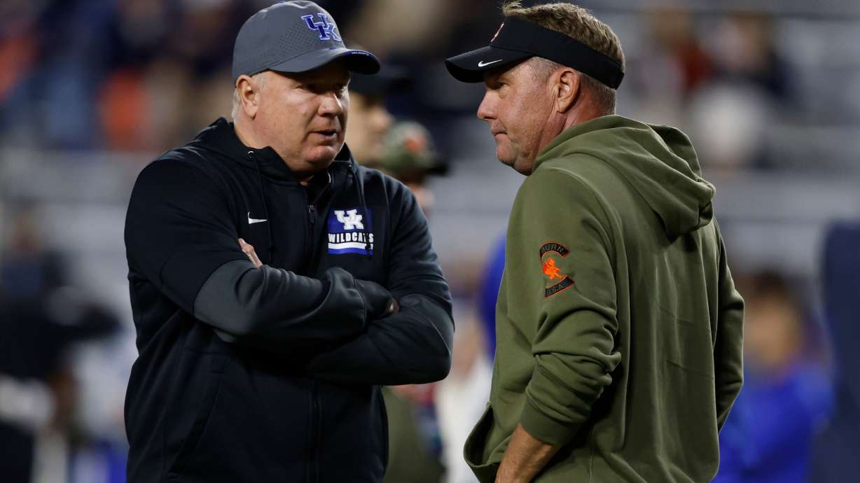 Kentucky head coach Mark Stoops talks with Auburn head coach Hugh Freeze before an NCAA college football game, Saturday, Nov. 1, 2025, in Auburn, Ala.
