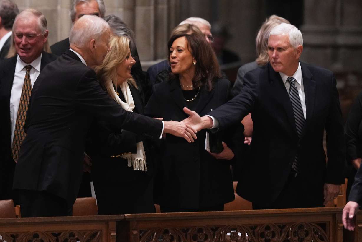 Former President Joe Biden shakes hands with former Vice President Mike Pence, with Jill Biden and former Vice President Kamala Harris, before the start of the funeral for former Vice President Dick Cheney at the Washington National Cathedral on Thursday in Washington. Biden, Harris and Pence were among several current and former politicians invited to the funeral.