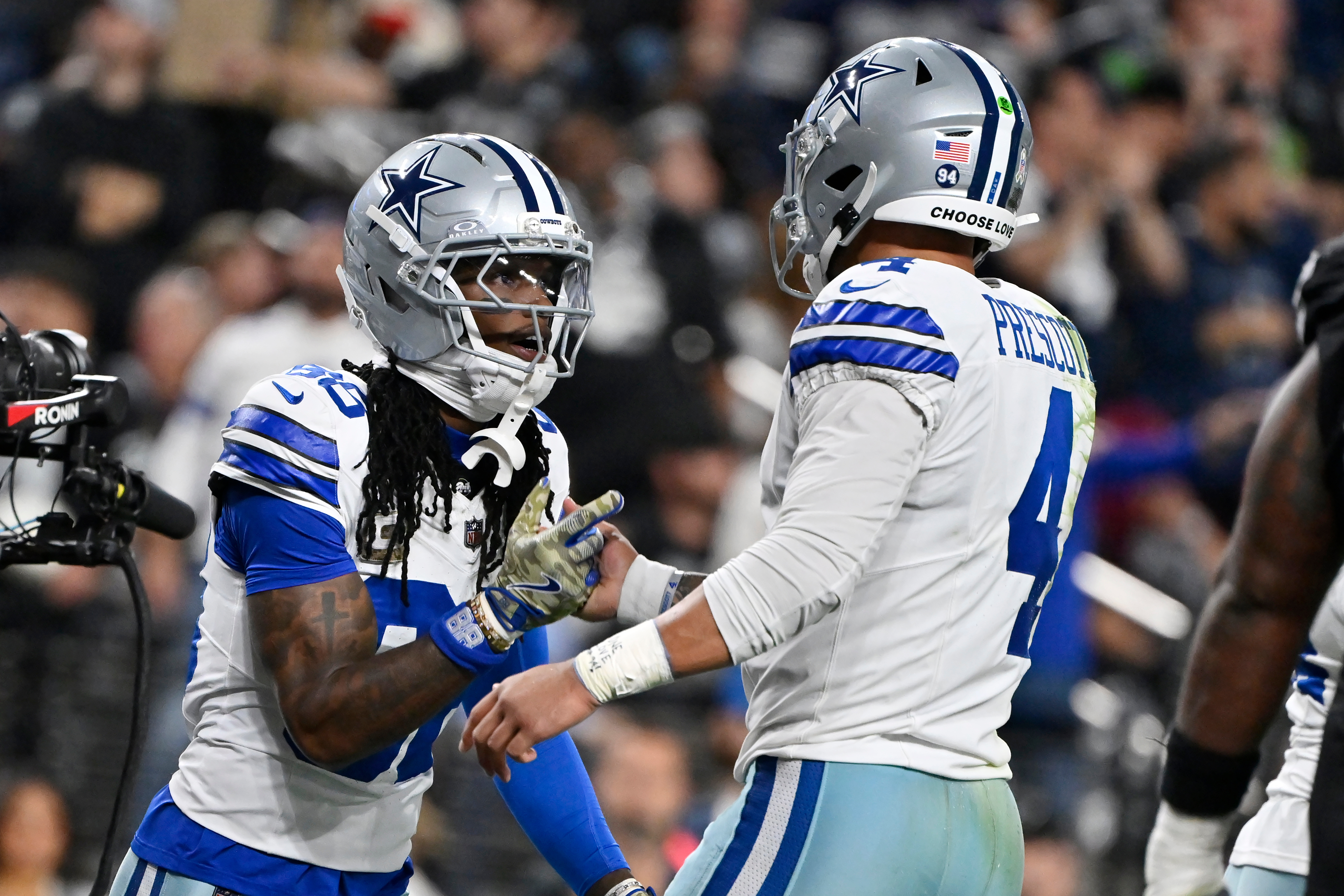Dallas Cowboys wide receiver CeeDee Lamb, left, celebrates his touchdown against the Las Vegas Raiders with Cowboys quarterback Dak Prescott (4) during the first half of an NFL football game Monday, Nov. 17, 2025, in Las Vegas. 