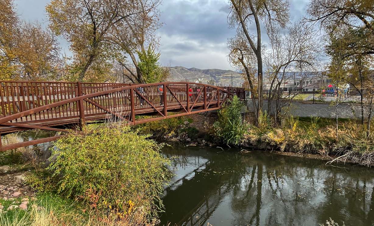 Students cross the Bridge to Backman over the Jordan River in Salt Lake City on Thursday. The bridge opened in 2022, as part of improvements in the area.
