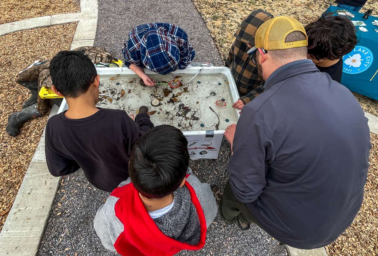 Backman Elementary School students learn about the Jordan River's ecosystem at a science station set up at Backman Community Open Space in Salt Lake City on Thursday.