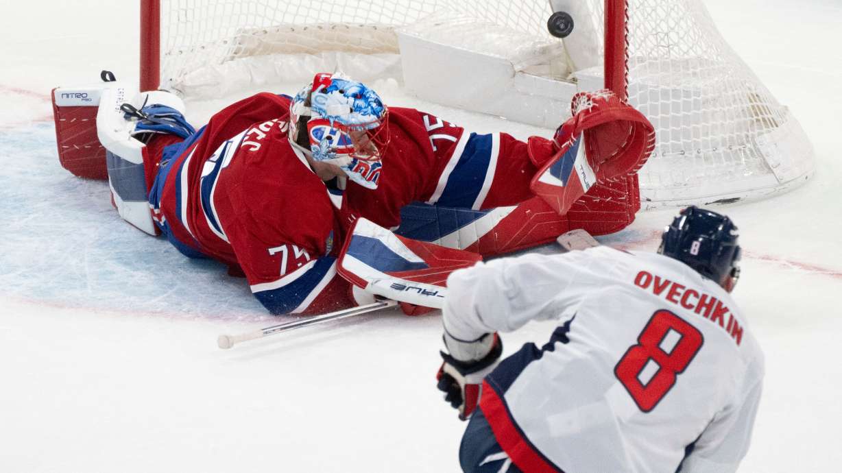 Washington Capitals' Alex Ovechkin (8) scores against Montreal Canadiens goaltender Jakub Dobes (75) during third-period NHL hockey game action in Montreal, Thursday, Nov. 20, 2025.
