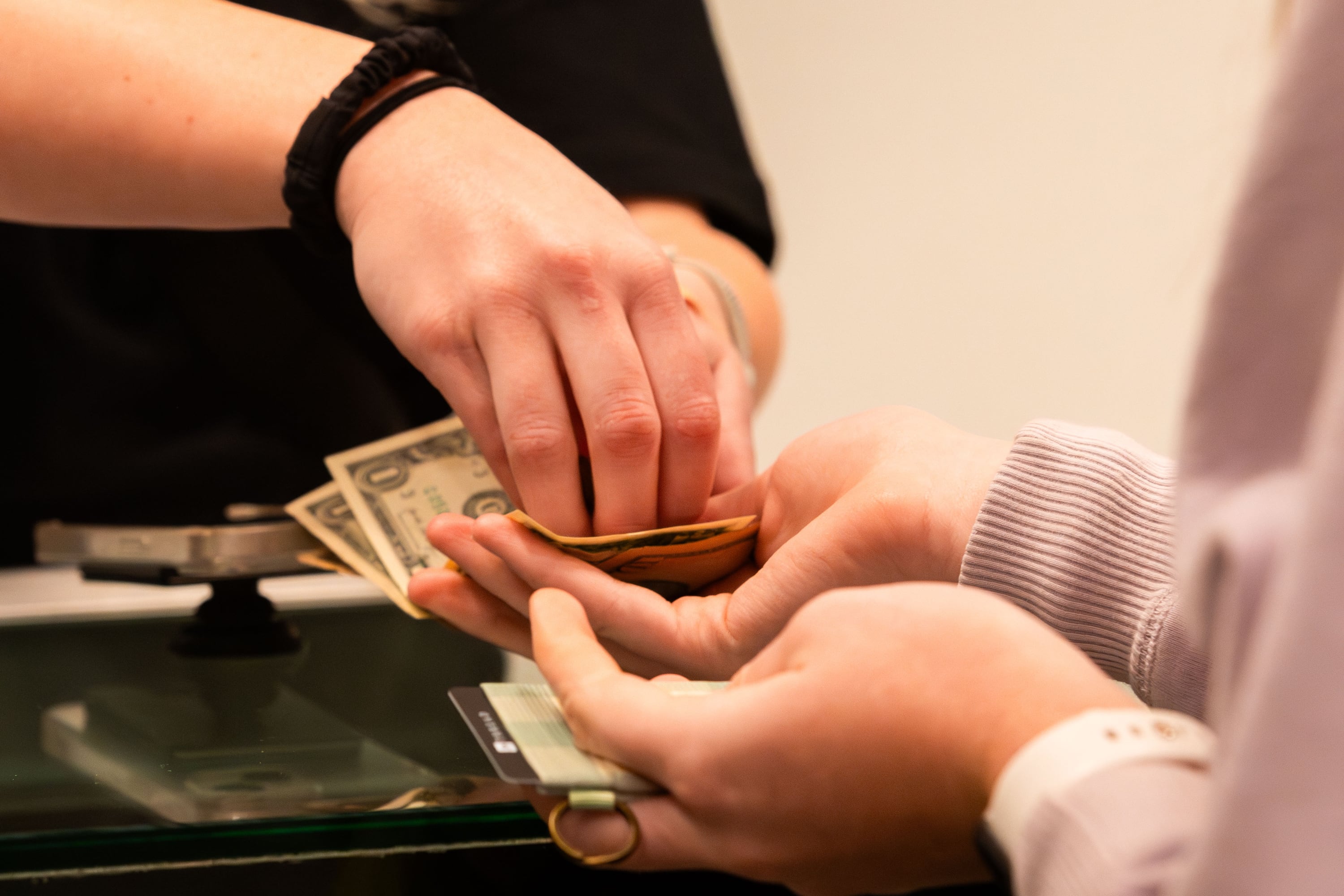 An employee gives change to a customer at Thread at City Creek Center in Salt Lake City on Friday, Nov. 24, 2023.