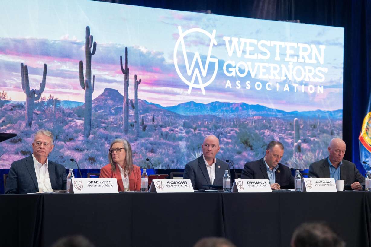 From left, Idaho Gov. Brad Little, Arizona Gov. Katie Hobbs, Utah Gov. Spencer Cox, Hawaii Gov. Josh Green and Montana Gov. Greg Gianforte listen during the Western Governors' Association meeting Thursday, in Scottsdale, Ariz.