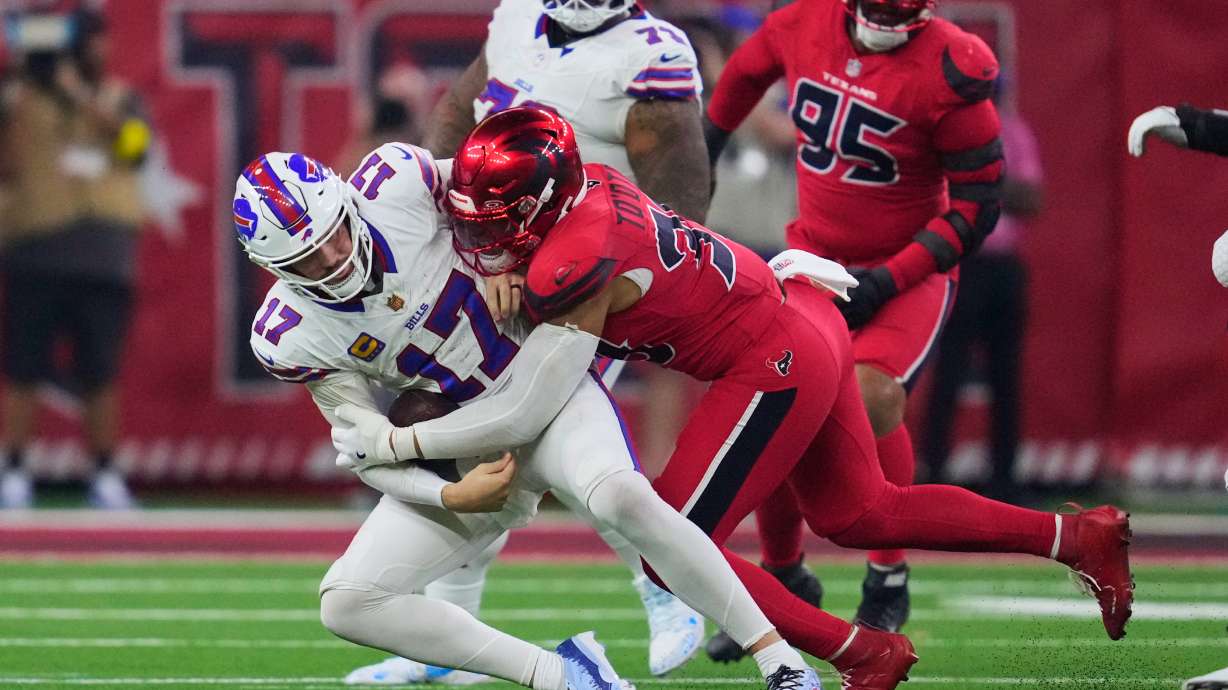 Buffalo Bills quarterback Josh Allen (17) is sacked by Houston Texans linebacker Henry To'oTo'o (39) in the second half of an NFL football game Thursday, Nov. 20, 2025, in Houston.