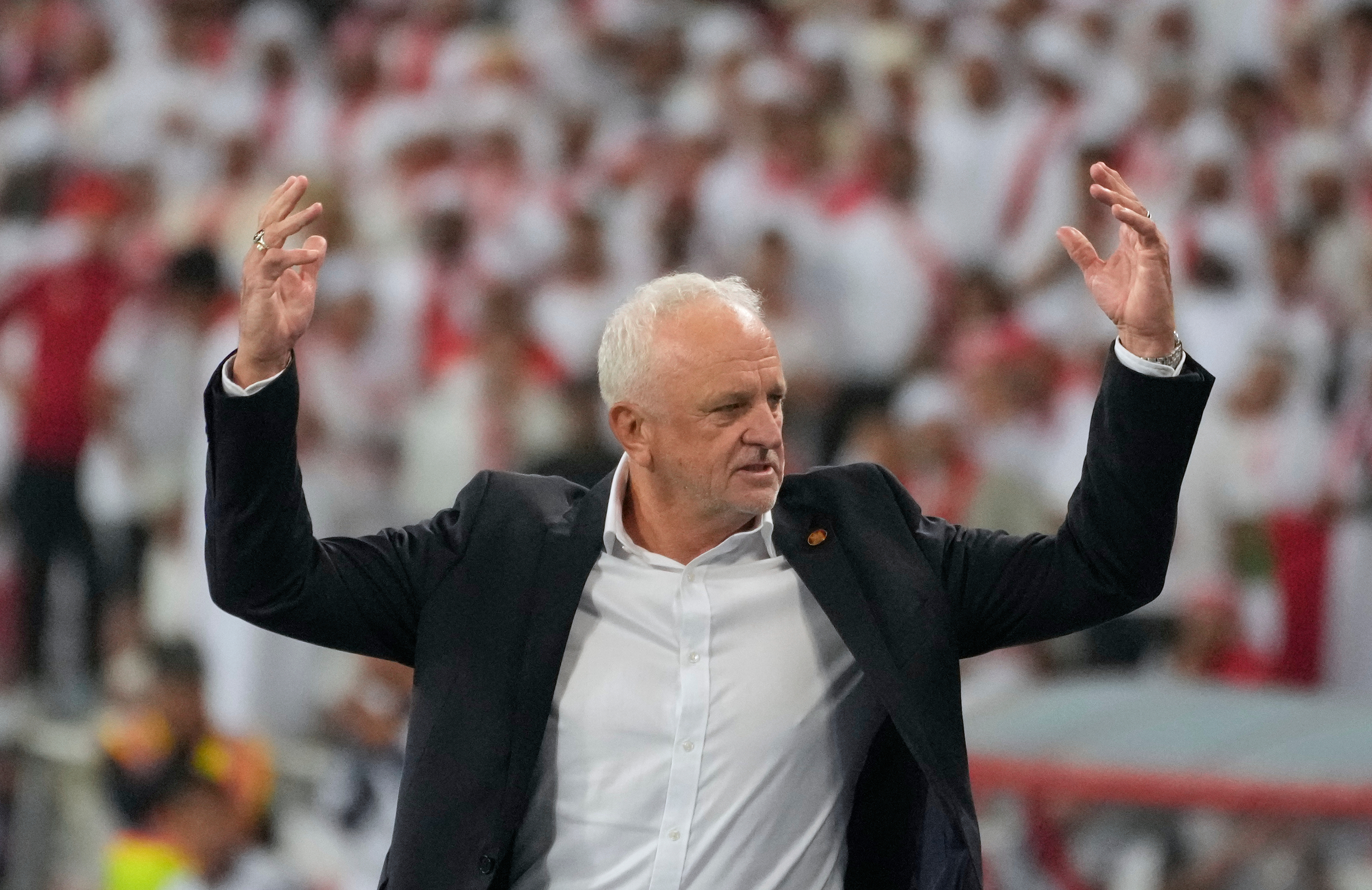 Iraqi's head coach Graham Arnold celebrates his team's win during the 2026 World Cup play off second leg soccer match between UAE and Iraq, in Basra, Iraq, Nov. 18, 2025. 