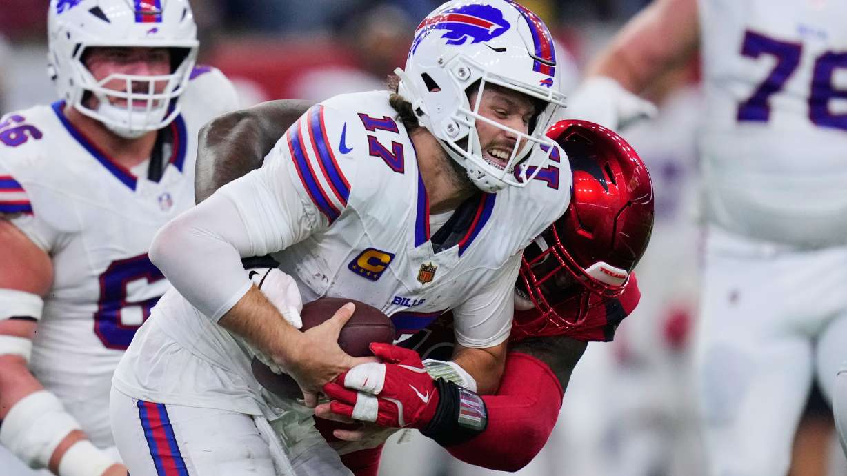 Buffalo Bills quarterback Josh Allen (17) is sacked by Houston Texans defensive tackle Mario Edwards Jr., rear, in the second half of an NFL football game Thursday, Nov. 20, 2025, in Houston.