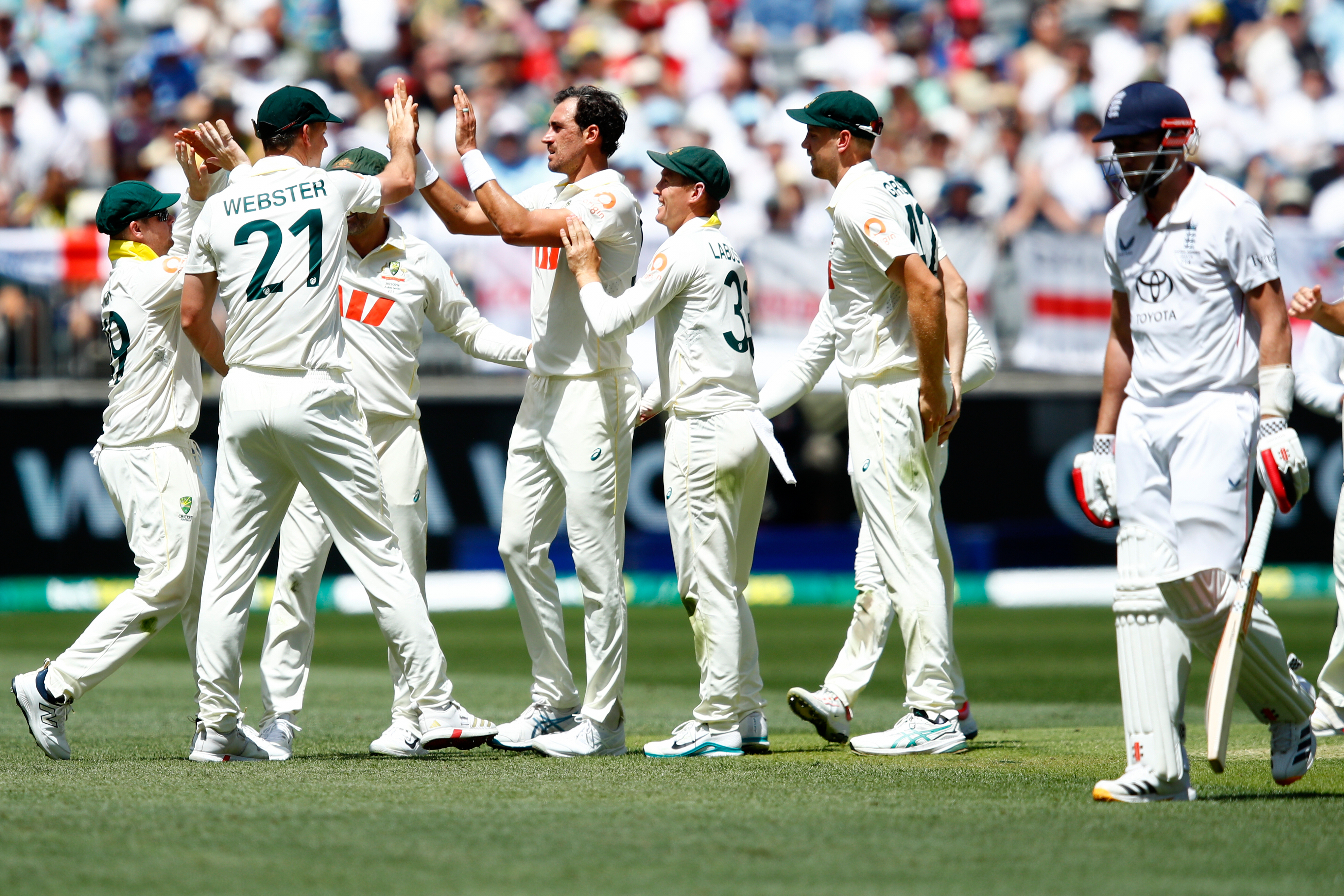 Australia's Mitchell Starc, center, celebrates with teammates the wicket of England's Gus Atkinson during the first Ashes cricket test match between Australia and England in Perth, Friday, Nov. 21, 2025.