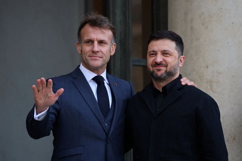 French President Emmanuel Macron welcomes Ukrainian President Volodymyr Zelenskyy as he arrives for a meeting at the Elysee Palace in Paris, France, Monday. Zelenskyy also met with the leaders of Britain and Germany, as well as Vice President JD Vance, to discuss a new U.S. peace plan that endorses key Russian demands.