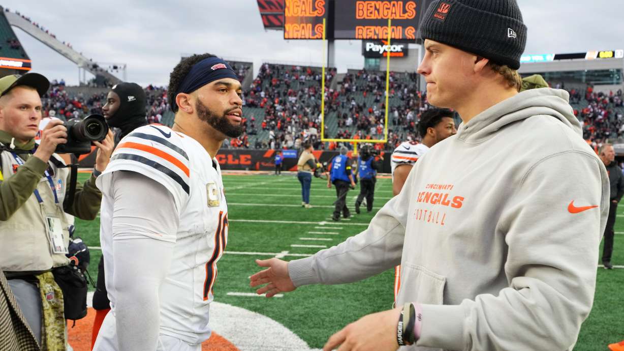 Cincinnati Bengals quarterback Joe Burrow (9), right, greets Chicago Bears quarterback Caleb Williams (18) after an NFL football game, Sunday, Nov. 2, 2025, in Cincinnati.