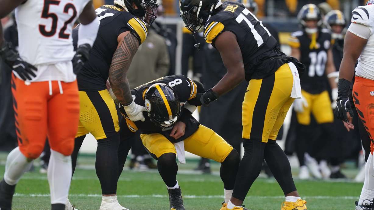 Pittsburgh Steelers quarterback Aaron Rodgers (8) is helped up off the field after a hit by the Cincinnati Bengals during the first half of an NFL football game Sunday, Nov. 16, 2025, in Pittsburgh.