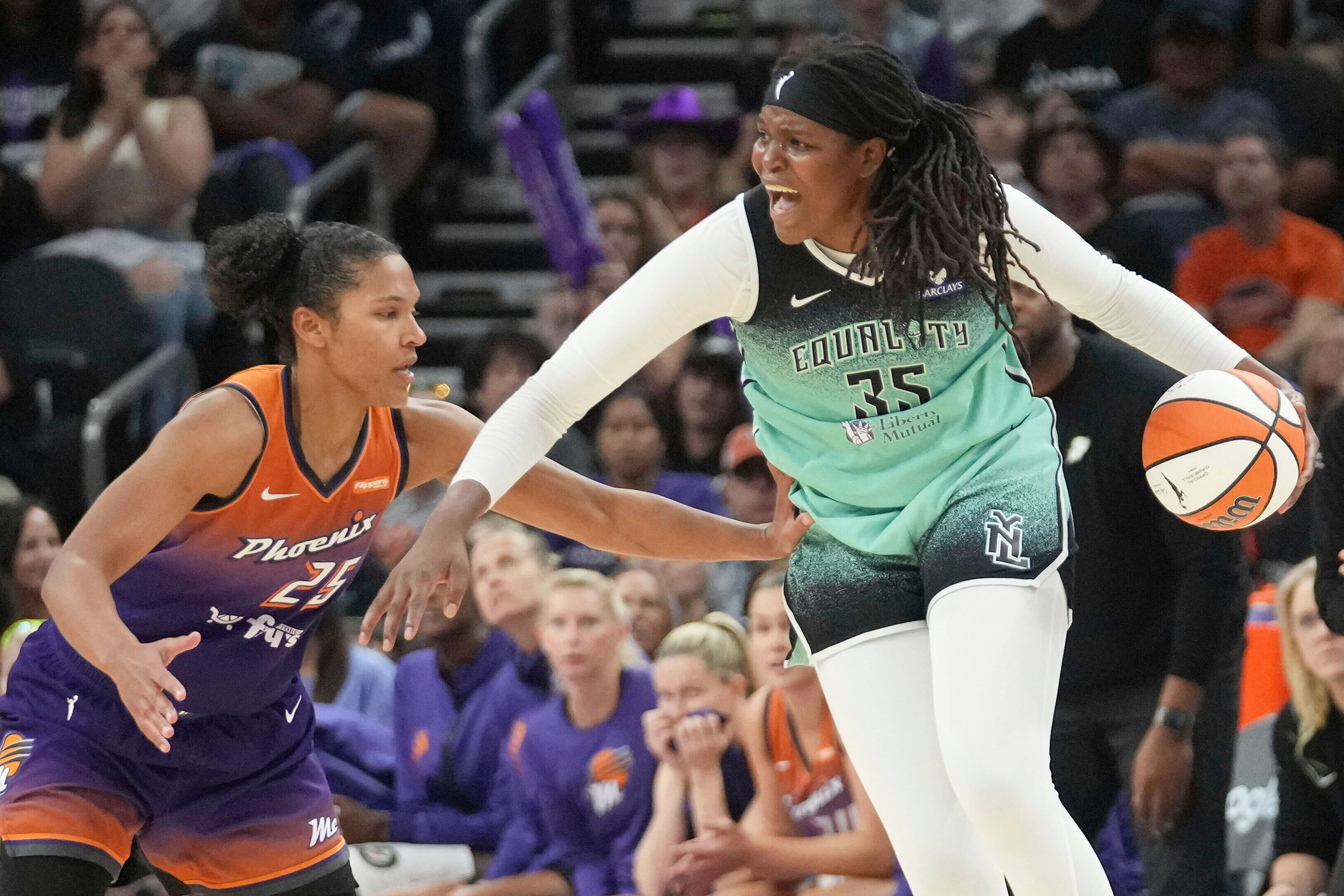 FILE - New York Liberty center Jonquel Jones (35) looks for an outlet against Phoenix Mercury forward Alyssa Thomas (25) during the second half of Game 1 during the first round of the WNBA basketball playoffs Sunday, Sept. 14, 2025, in Phoenix. 