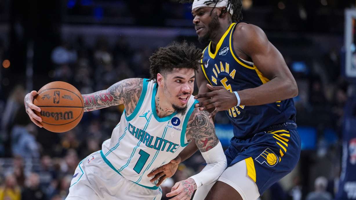 Charlotte Hornets guard Lamelo Ball (1) drives on Indiana Pacers forward Jarace Walker (5) during the first half of an NBA basketball game in Indianapolis, Wednesday, Nov. 19, 2025.