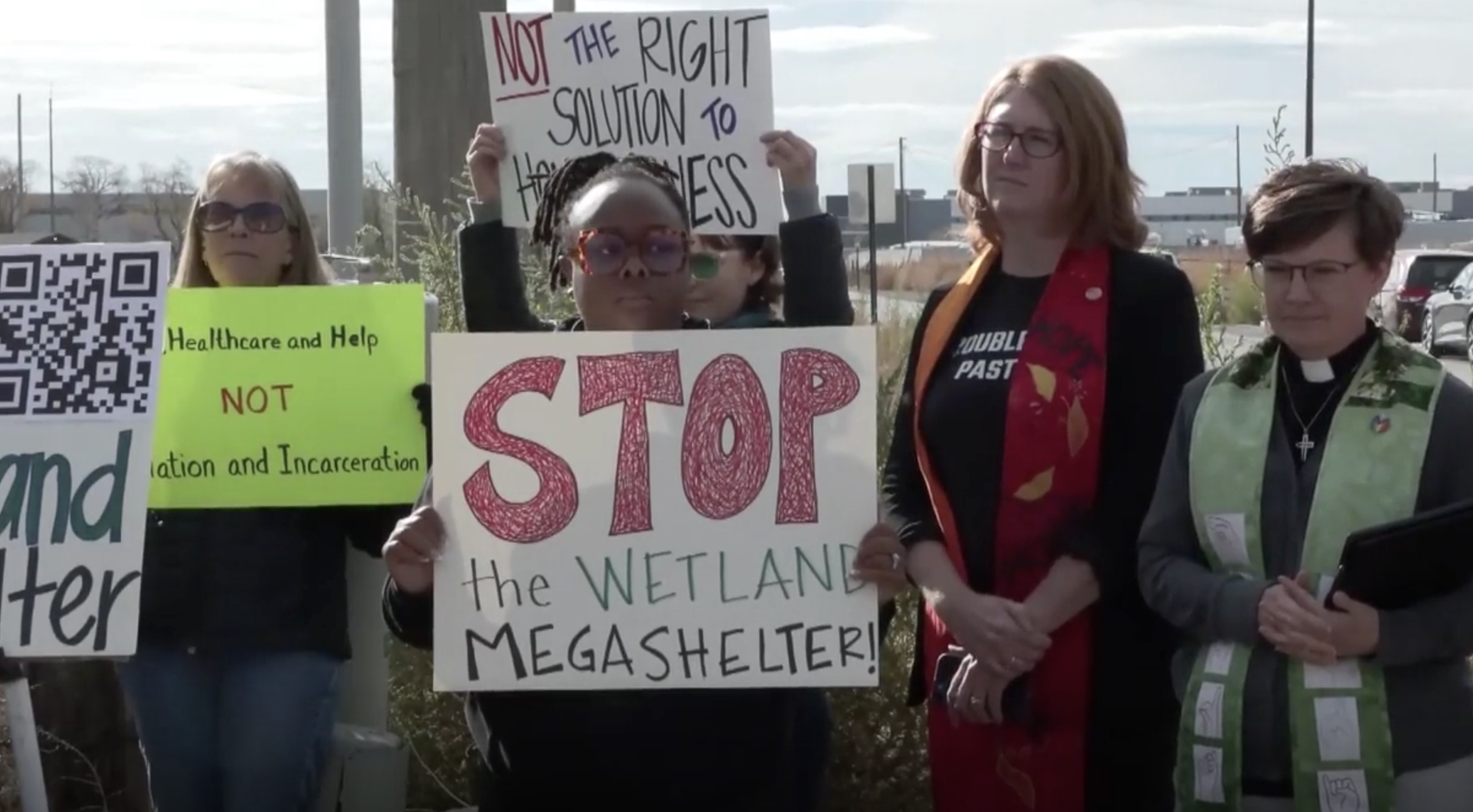 People protest near the site of a proposed homeless campus site in Salt Lake City's Northpoint area on Tuesday.