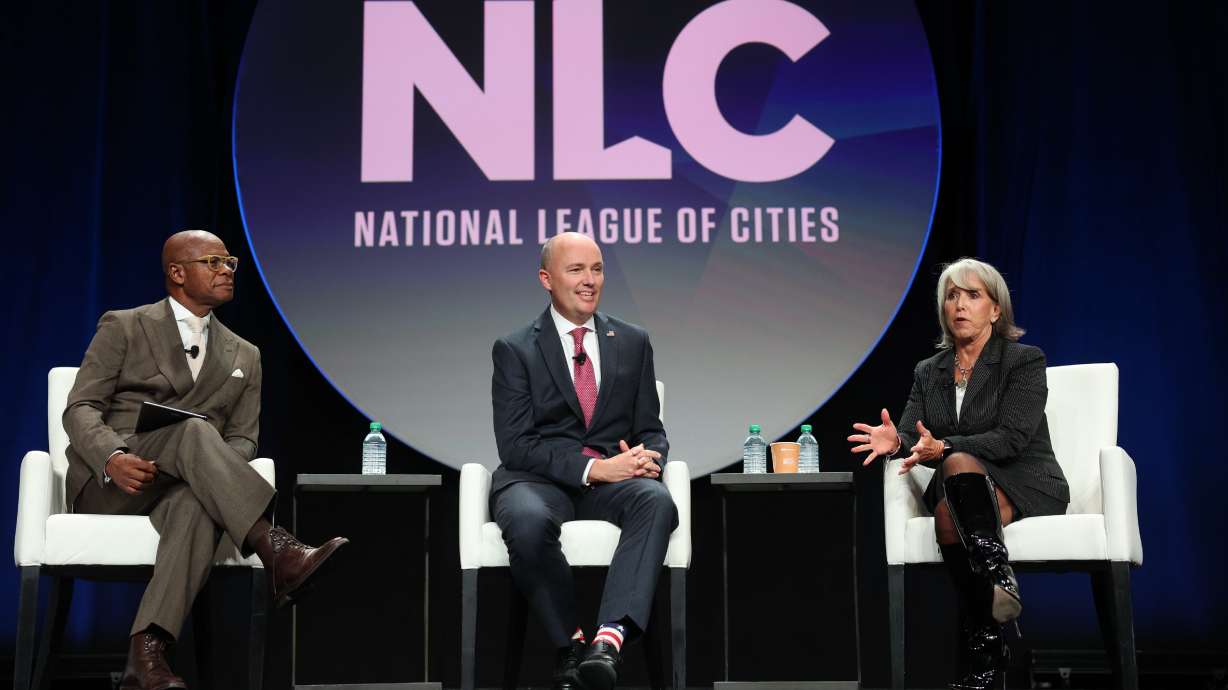 Clarence E. Anthony moderates a discussion between Utah Gov. Spencer Cox and New Mexico Gov. Michelle Lujan Grisham, Friday, at the National League of Cities’ 2025 City Summit in Salt Lake City.
