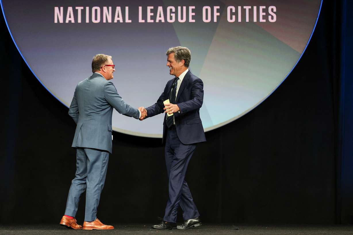 University of Utah President Taylor Randall shakes hands with Tim Shriver, co-creator of the Dignity Index, Friday, at the National League of Cities’ 2025 City Summit in Salt Lake City. Shriver is a visiting faculty member at the university.