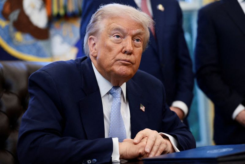 President Donald Trump looks on as he meets with the White House Task Force on the 2026 FIFA World Cup in the Oval Office at the White House in Washington, Monday. Trump called Rep. Marjorie Taylor Greene's resignation "great news."