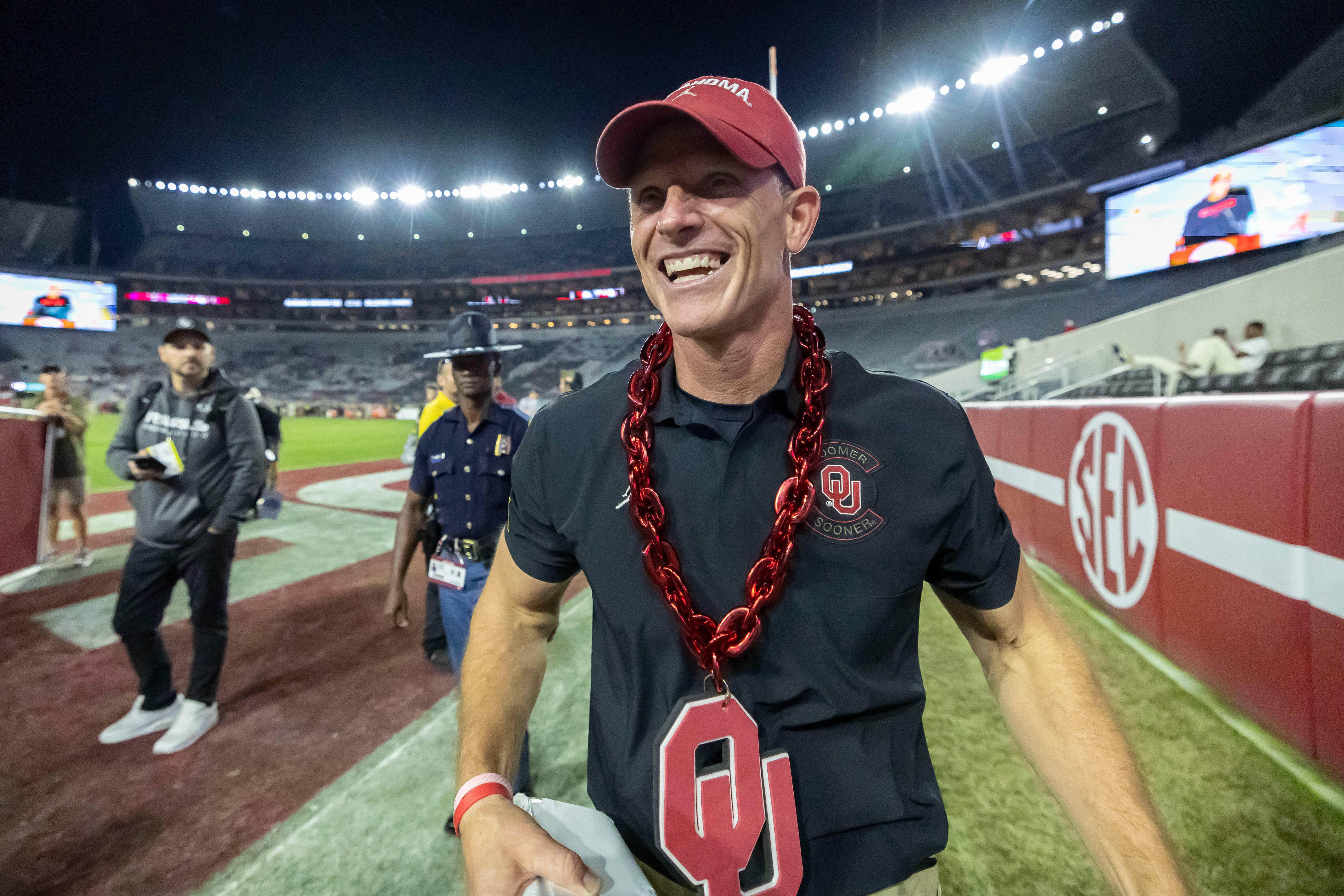Oklahoma head coach Brent Venables wears an Oklahoma chain given to him postgame by a fan as he walks into the locker room after defeating Alabama at an NCAA college football game, Saturday, Nov. 15, 2025, in Tuscaloosa, Ala. 