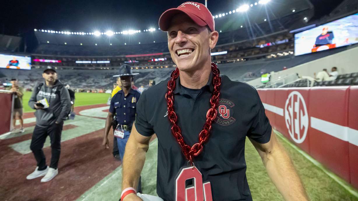 Oklahoma head coach Brent Venables wears an Oklahoma chain given to him postgame by a fan as he walks into the locker room after defeating Alabama at an NCAA college football game, Saturday, Nov. 15, 2025, in Tuscaloosa, Ala.